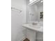 Stylish powder room features a pedestal sink, updated fixture, and mirror at 2148 Nims Village Dr, Fort Mill, SC 29715