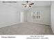 Bright primary bedroom with neutral carpet, vaulted ceilings, a window, and a ceiling fan with light at 217 Lake George Dr, Shelby, NC 28152