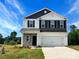 Charming two-story home with a two-car garage, stone accents, and a well-maintained front yard at 217 Lake George Dr, Shelby, NC 28152