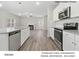 Open-concept kitchen with stainless steel appliances, granite countertops, and a view of the living room at 217 Lake George Dr, Shelby, NC 28152