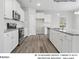 Modern kitchen featuring stainless steel appliances, granite countertops, and ample white cabinetry at 217 Lake George Dr, Shelby, NC 28152