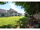 Expansive backyard featuring lush lawn, privacy fence, and view of the home's rear facade at 219 Harrowfield Hts, York, SC 29745