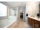 Bright bathroom featuring a soaking tub, walk-in shower, double vanity, and walk-in closet at 219 Harrowfield Hts, York, SC 29745
