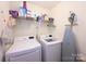 Functional laundry room equipped with washer, dryer, shelving, and ironing board for convenience at 219 Harrowfield Hts, York, SC 29745