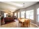 Open-concept living area adjacent to dining with fireplace and ample windows at 219 Harrowfield Hts, York, SC 29745