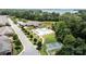 Stunning aerial perspective of lakefront property featuring a pool, tennis court, and lush landscaping at 2484 Early Richmond Ct, Denver, NC 28037