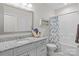 Well-lit bathroom featuring a granite countertop vanity, toilet, and shower/tub combo with a stylish shower curtain at 2484 Early Richmond Ct, Denver, NC 28037