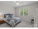 Cozy bedroom with natural light, a plush bed, carpeted floors, and a ceiling fan, creating a relaxing atmosphere at 2484 Early Richmond Ct, Denver, NC 28037