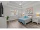 Bright bedroom with hardwood floors, tray ceiling, and a decorative painting creating a cozy and inviting space at 2484 Early Richmond Ct, Denver, NC 28037