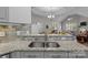 Open concept kitchen with granite countertops and stainless steel sink offers seamless flow to living spaces at 2484 Early Richmond Ct, Denver, NC 28037