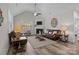 Spacious living room with vaulted ceilings, a fireplace, and ample natural light creating a cozy atmosphere at 2484 Early Richmond Ct, Denver, NC 28037