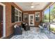 Inviting screened porch with ample seating, overhead fan, and brick accents at 2484 Early Richmond Ct, Denver, NC 28037