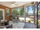 Cozy screened porch featuring comfortable seating, ceiling fan, and beautiful view at 2484 Early Richmond Ct, Denver, NC 28037
