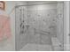 Modern walk-in shower featuring stylish gray tiling, a glass door, and convenient grab bars for added accessibility at 2484 Early Richmond Ct, Denver, NC 28037
