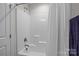 Clean shower stall with a white shower curtain, chrome fixtures, and built in shelves at 2484 Early Richmond Ct, Denver, NC 28037