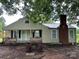 Front exterior view of house with chimney and wooden porch at 30497 Orchard Ln, Albemarle, NC 28001