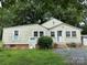 Back exterior view of home with partial brick foundation at 30497 Orchard Ln, Albemarle, NC 28001
