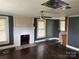 Living room with white brick fireplace, ceiling fan and windows at 30497 Orchard Ln, Albemarle, NC 28001