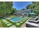 An overview of a backyard with a pool, outdoor seating, and solar panels on the house roof at 3165 Pendleton Ave, Charlotte, NC 28210