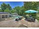 Spacious backyard retreat boasts a pool, outdoor dining, a fire pit, and lush green surroundings at 3165 Pendleton Ave, Charlotte, NC 28210