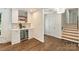 Stylish bar area with open shelving, decorative tile backsplash, and a built-in beverage cooler, perfect for entertaining guests at 3165 Pendleton Ave, Charlotte, NC 28210