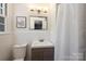 Charming bathroom features tiled walls, a modern vanity, and ample natural light from the window at 3165 Pendleton Ave, Charlotte, NC 28210