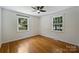 Spacious bedroom with wood floors, light walls, a ceiling fan, and large windows offering lots of sunlight at 3165 Pendleton Ave, Charlotte, NC 28210