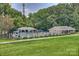 Community pool with lounge chairs and shade featuring green lawns at 3165 Pendleton Ave, Charlotte, NC 28210