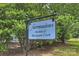 Sign for Fairmeadows Swim & Racquet Club surrounded by lush greenery at 3165 Pendleton Ave, Charlotte, NC 28210