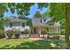 Charming two-story home with a brick and siding exterior, manicured lawn, and mature trees, creating a welcoming curb appeal at 3165 Pendleton Ave, Charlotte, NC 28210