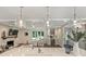 Open living room and kitchen with stone fireplace, coffered ceiling, and modern accents at 3165 Pendleton Ave, Charlotte, NC 28210