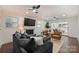 Inviting living room with stylish seating, ceiling fans, fireplace, and sliding glass doors to a covered outdoor area at 3165 Pendleton Ave, Charlotte, NC 28210