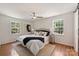 Bright main bedroom with hardwood floors, a ceiling fan, and two large windows offering natural light at 3165 Pendleton Ave, Charlotte, NC 28210