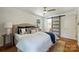 Bright main bedroom features hardwood floors, a ceiling fan, and an en suite bathroom with a sliding door at 3165 Pendleton Ave, Charlotte, NC 28210