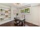 Bright home office featuring custom built-in shelves, a modern light fixture, and a large window with a view of the outdoors at 3165 Pendleton Ave, Charlotte, NC 28210