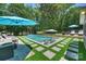 Luxury outdoor pool space featuring lounge chairs, a seating area, and lush, private landscaping at 3165 Pendleton Ave, Charlotte, NC 28210