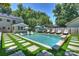 Relaxing pool area with ample seating, lush landscaping, and a spacious patio for outdoor entertaining at 3165 Pendleton Ave, Charlotte, NC 28210