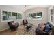 Bright sunroom with lots of windows, wicker furniture, neutral tile floor and a view of the pool at 3165 Pendleton Ave, Charlotte, NC 28210