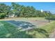 Outdoor basketball court with well-maintained surface surrounded by green grass and trees at 3511 Dominion Green Dr, Charlotte, NC 28269