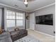 Relaxing bonus room featuring a plush chaise lounge and mounted TV at 3511 Dominion Green Dr, Charlotte, NC 28269