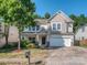 Charming two-story home with a well-manicured lawn and a two-car garage at 3511 Dominion Green Dr, Charlotte, NC 28269