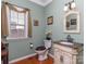 Powder room featuring hardwood floors, pedestal sink with marble countertop, and decorative mirror at 3511 Dominion Green Dr, Charlotte, NC 28269