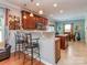 Bright eat-in kitchen featuring wood floors, cherry cabinets, granite counters, and seating at the breakfast bar at 3511 Dominion Green Dr, Charlotte, NC 28269