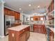 A spacious kitchen featuring stainless steel appliances, a center island, and warm wood cabinetry at 3511 Dominion Green Dr, Charlotte, NC 28269
