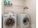 Functional laundry room with a front-loading washer and dryer and wire shelving at 3511 Dominion Green Dr, Charlotte, NC 28269