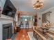 Open-concept living area with a fireplace, breakfast bar, and hardwood floors at 3511 Dominion Green Dr, Charlotte, NC 28269