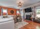 Cozy living room boasts a decorative fireplace, hardwood floors, and abundant natural light at 3511 Dominion Green Dr, Charlotte, NC 28269