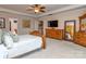 Primary bedroom featuring tray ceilings, ceiling fan, and en suite bath access at 3511 Dominion Green Dr, Charlotte, NC 28269