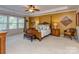 Large primary bedroom with decorative wall, ceiling fan, and an abundance of natural light at 3511 Dominion Green Dr, Charlotte, NC 28269