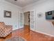Bright office space with hardwood floors, french doors, and a decorative chair at 3511 Dominion Green Dr, Charlotte, NC 28269